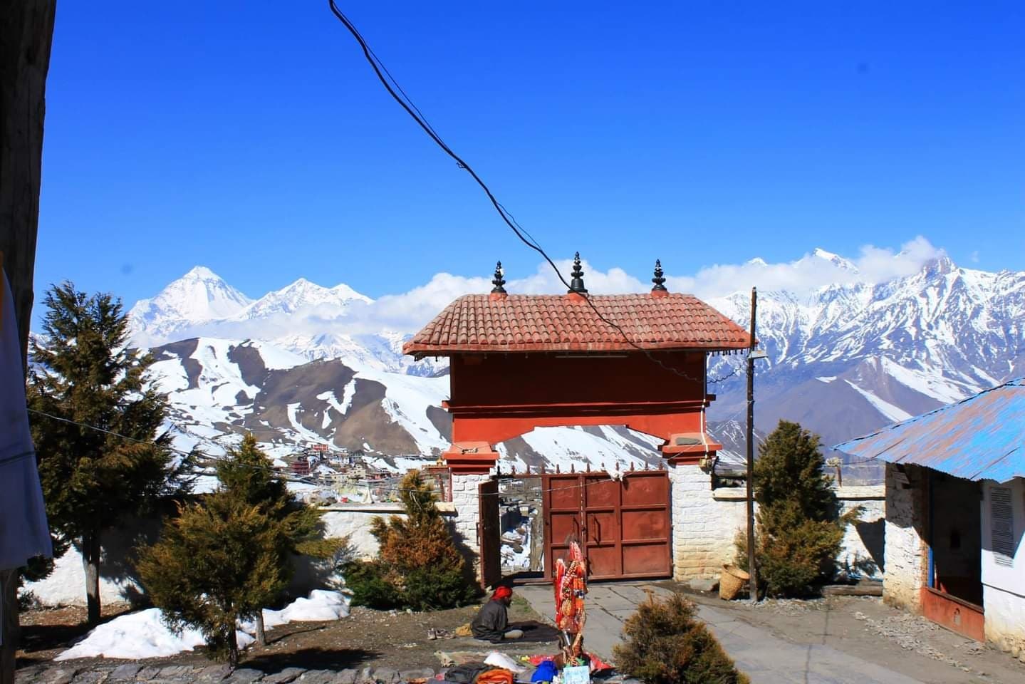 Mountain temple below snow-capped peaks