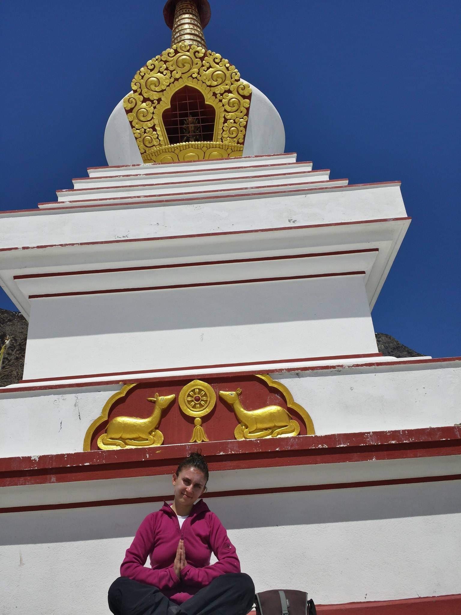 Elis meditating in front of a Buddhist stupa