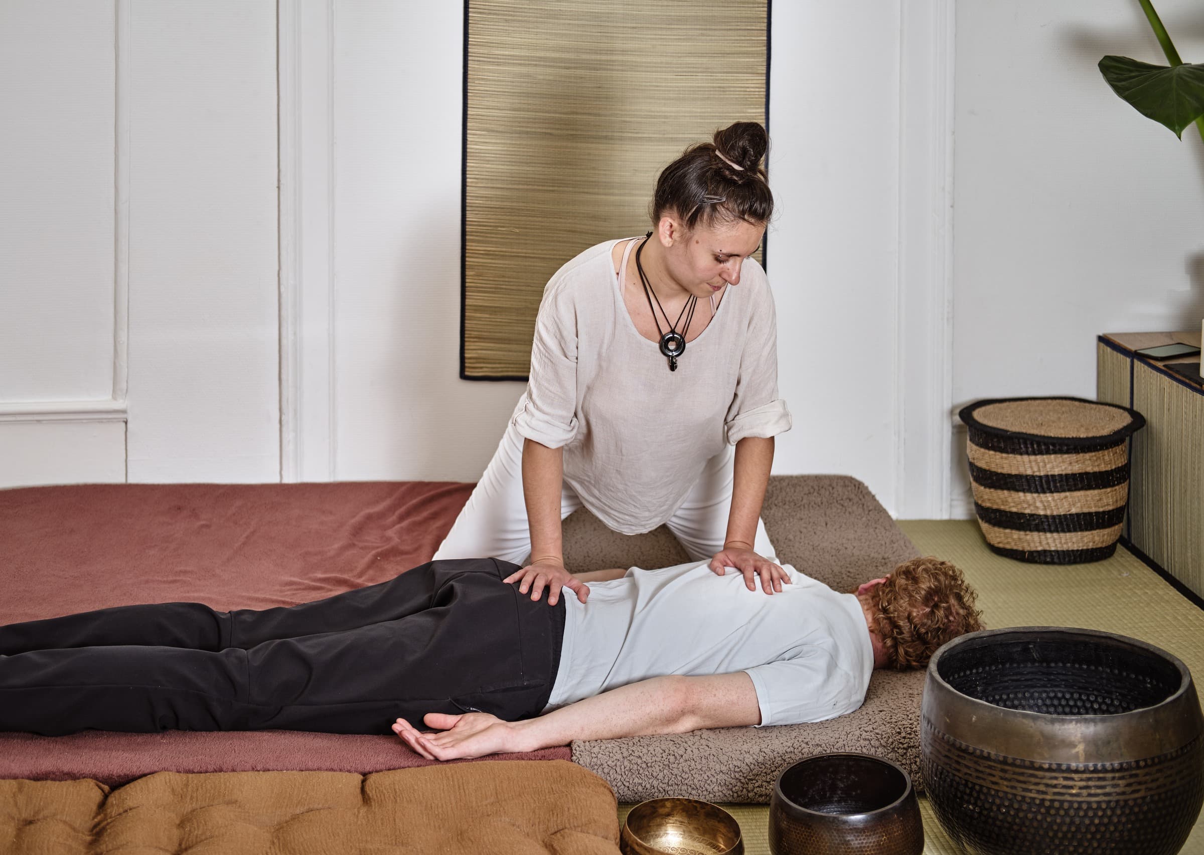 Elis applying Shiatsu pressure along a client's back